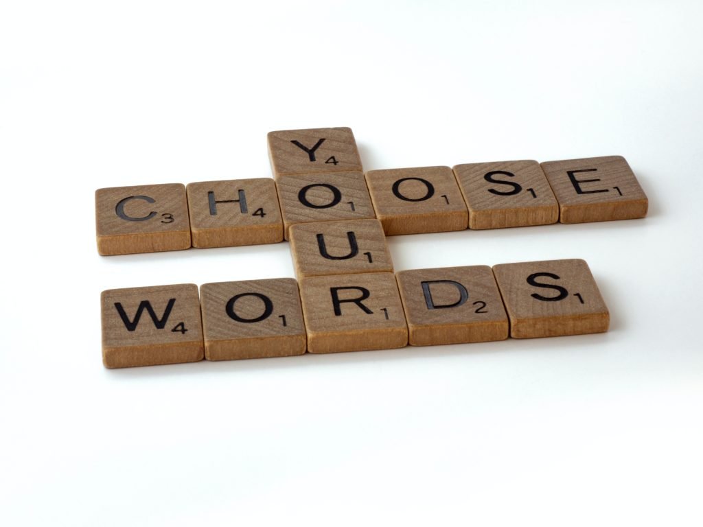 "You choose your words" written with Scrabble pieces