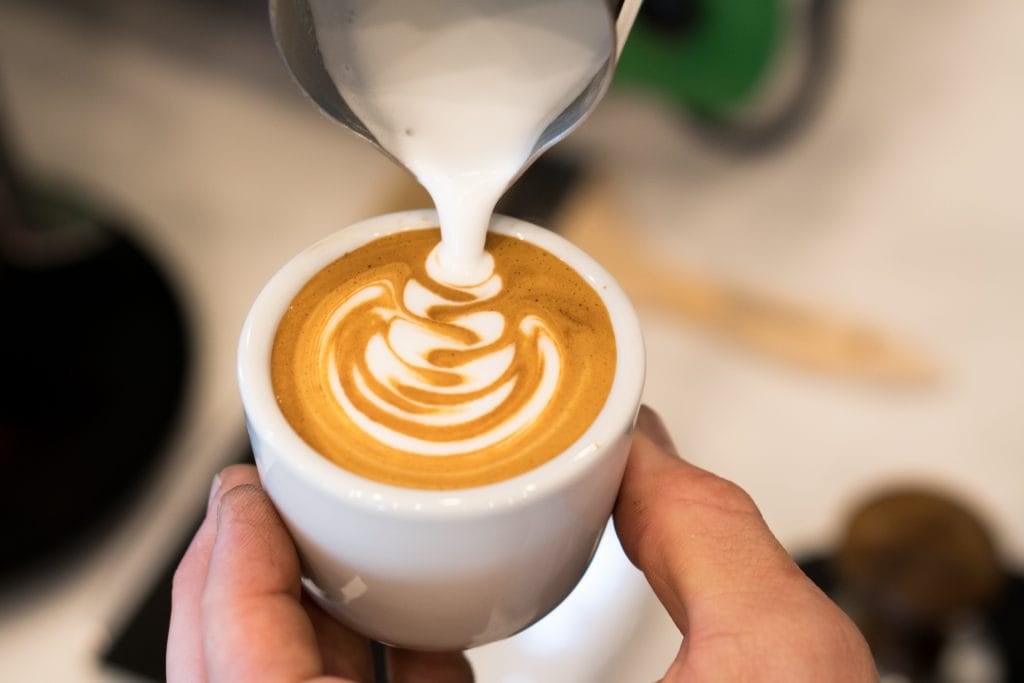 Making latte art in a cortado