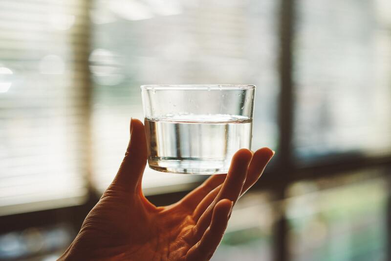 Water quality is essential for coffee brewing and long-lasting coffee gear. In the picture, a glass of water.